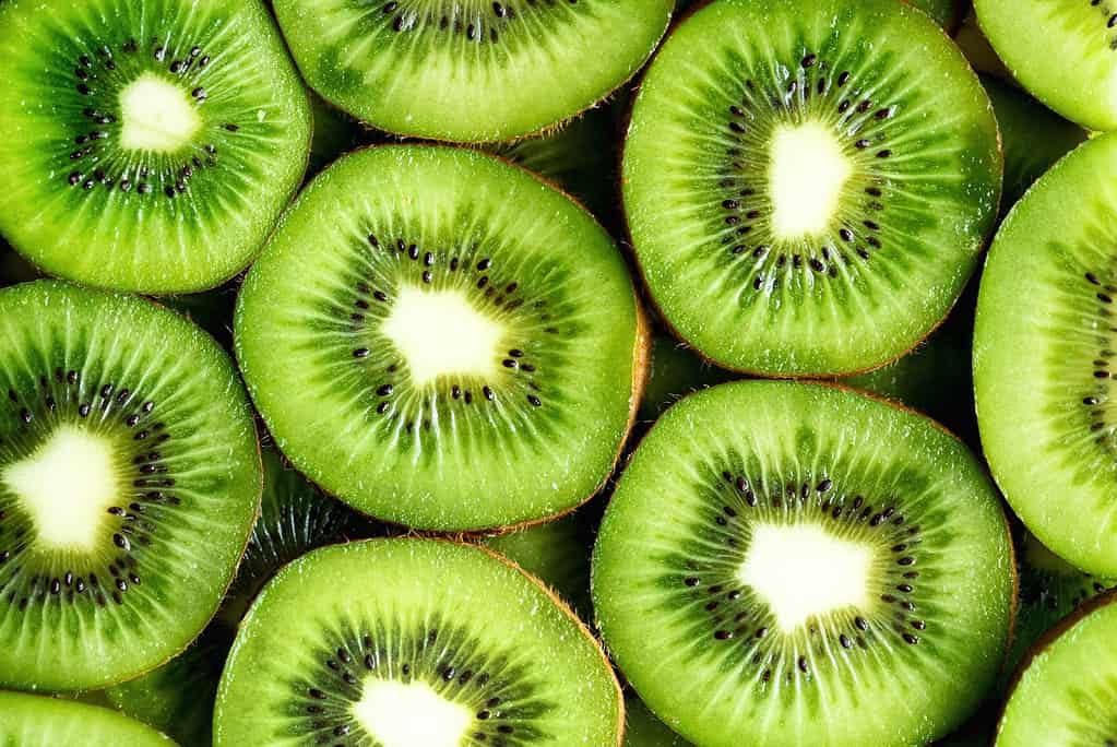 Vibrant kiwi slices showcasing bright green flesh and tiny black seeds, symbolizing freshness and health.