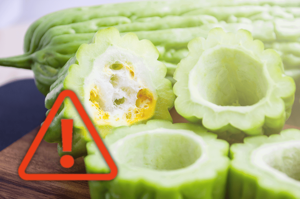 Fresh sliced bitter melon vegetable, healthy food concept, caution sign for potential health risks.
