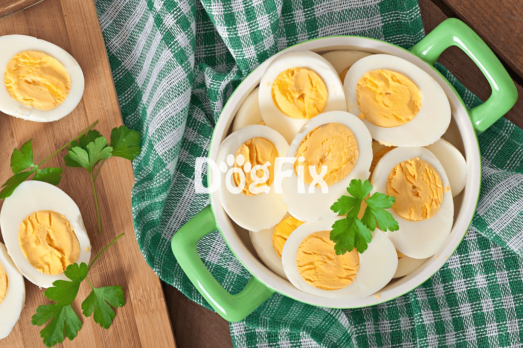 Alt text: Sliced boiled eggs in a green bowl with parsley, on a checkered cloth.