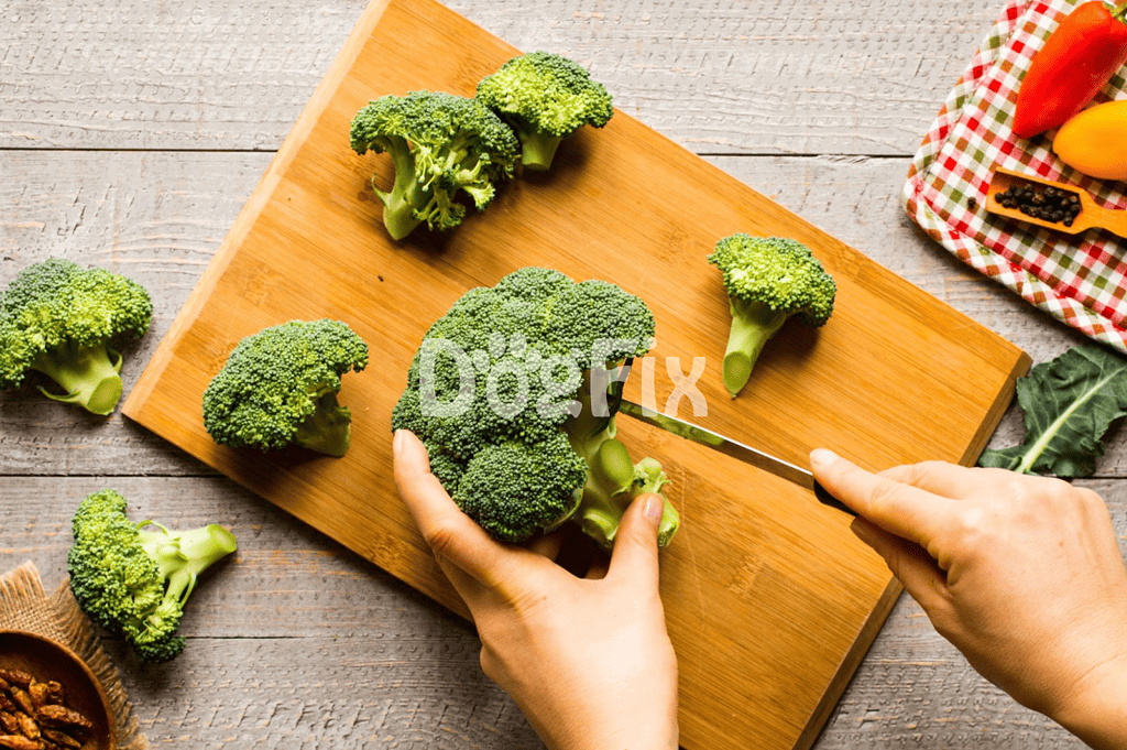 Bright green broccoli florets on wooden cutting board for nutritious dog food recipes.