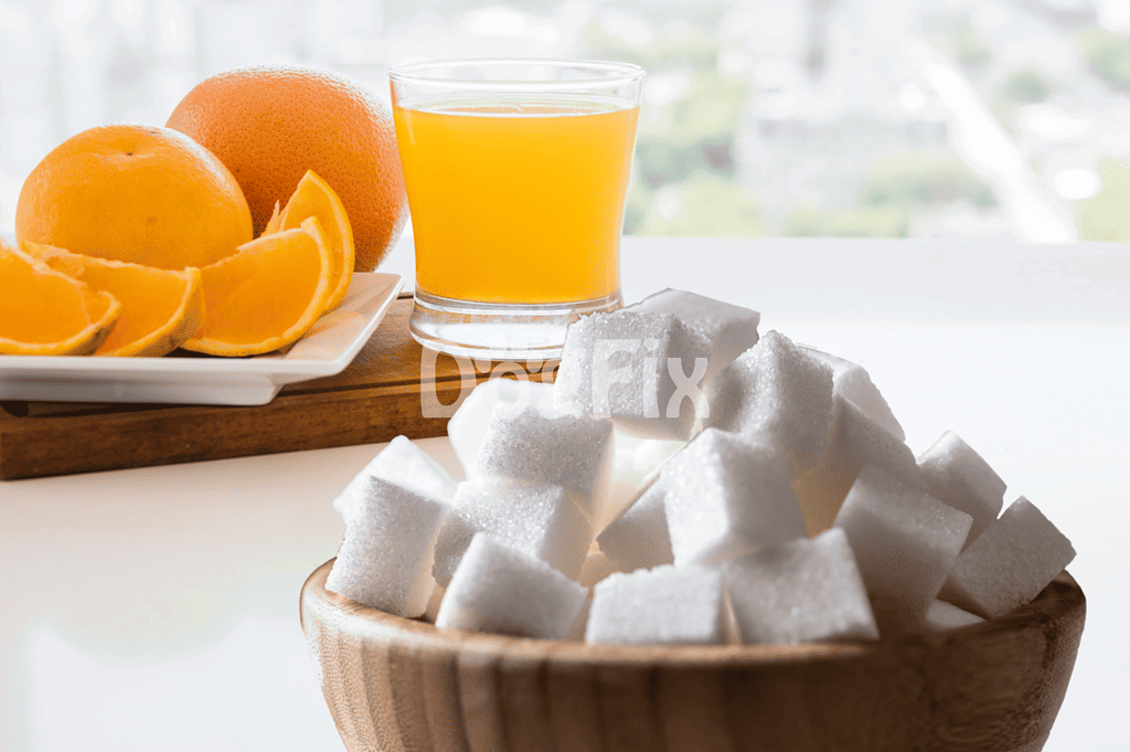 Fresh orange juice, oranges, and sugar cubes on a bright table for dog-friendly snacks.