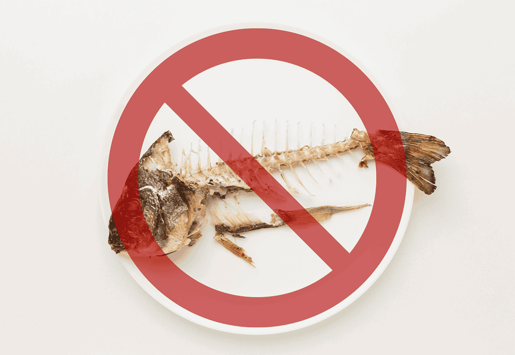 Fish bones on a plate with 'no' symbol overlay.