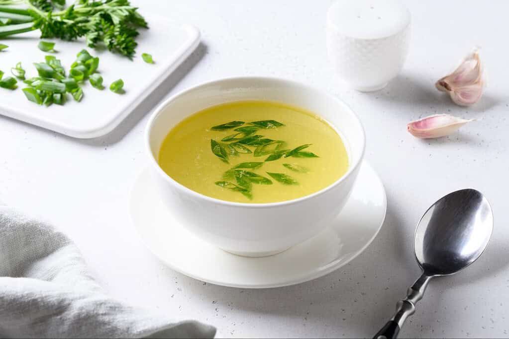 Delicious homemade vegetable broth with fresh herbs and garlic. Perfect for nutritious, healthy meals.