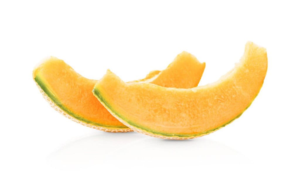 Vibrant orange cantaloupe slices with green rind, showcasing a juicy, sweet interior.