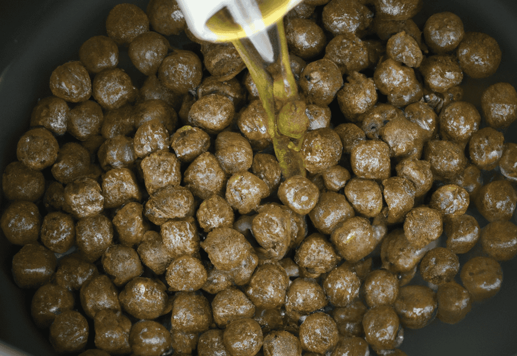 High-quality dry dog food being prepared in a pan.