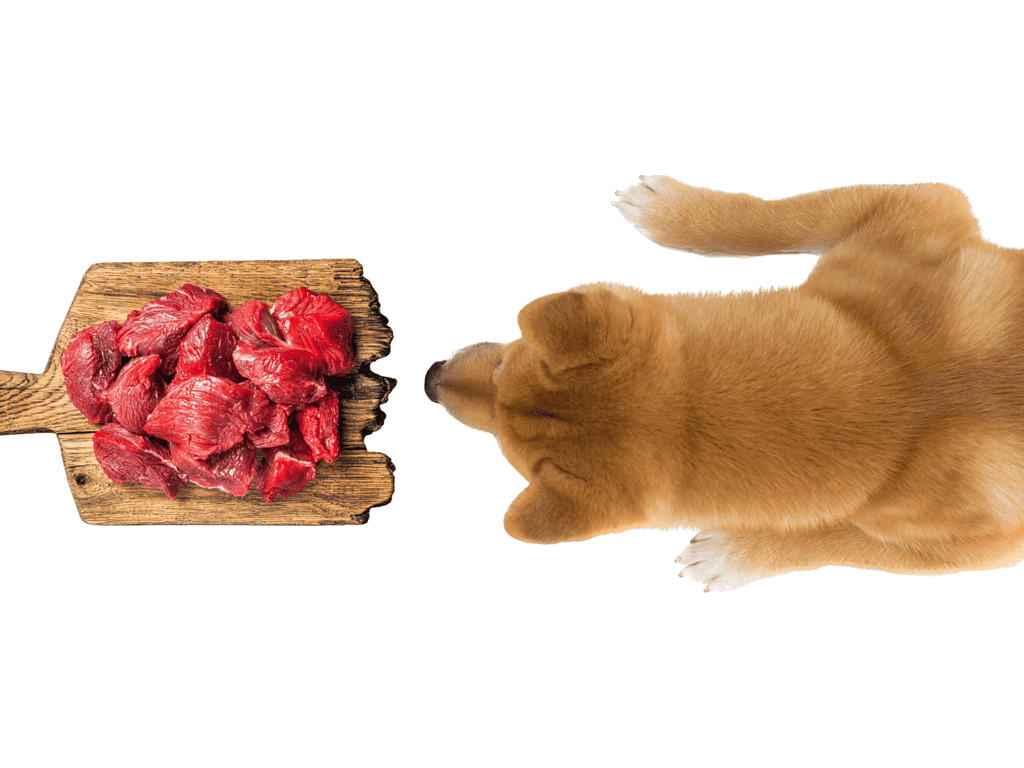 Image of raw, tender beef chunks on a rustic wooden board.