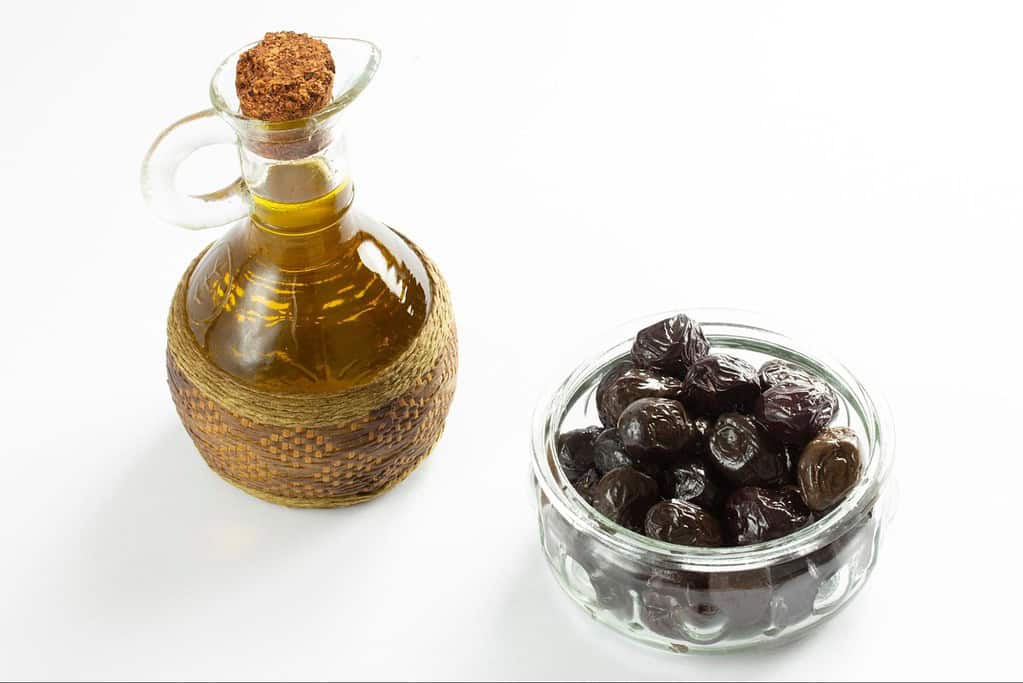 Oil and dates in a glass bottle and bowl, healthy dog treats, natural supplements for dogs.