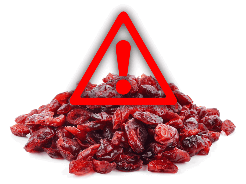 Warning sign overlay on dried berries poses health risk to dogs.