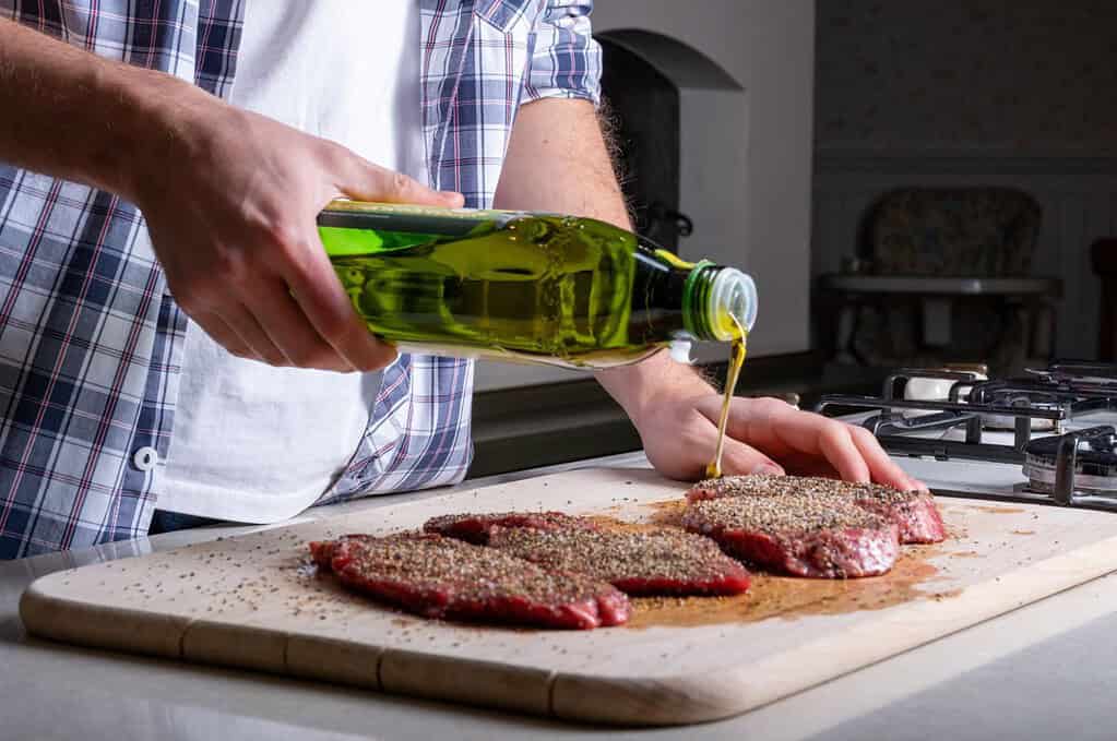 Clean cooking of steak with oil in kitchen for pet nutrition tips.