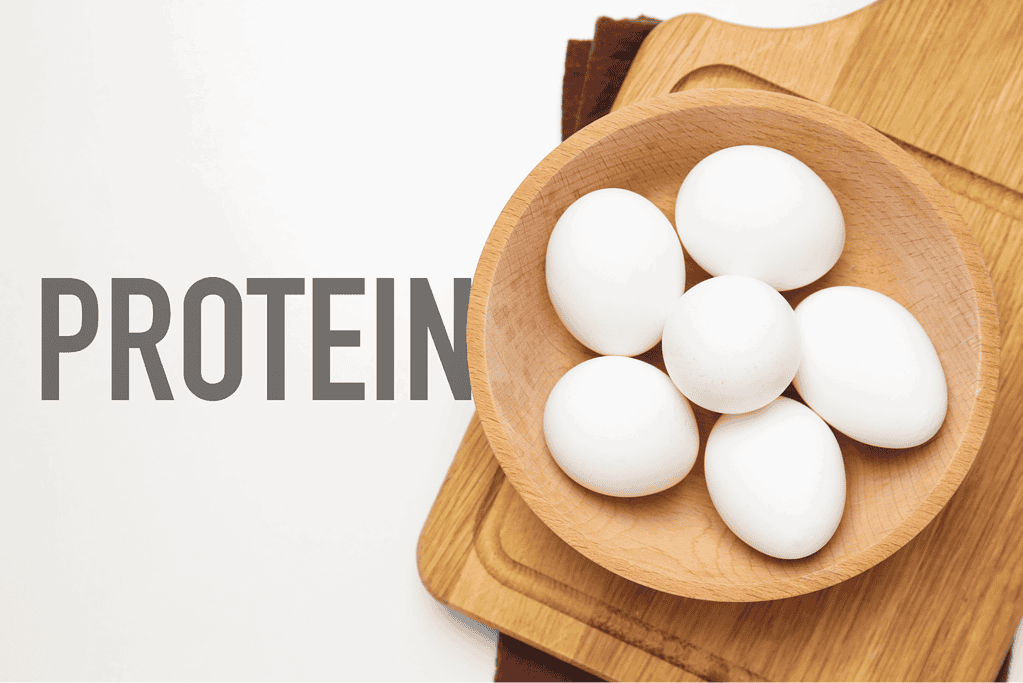 Fresh eggs in a wooden bowl, highlighting healthy protein options for dogs' diets.
