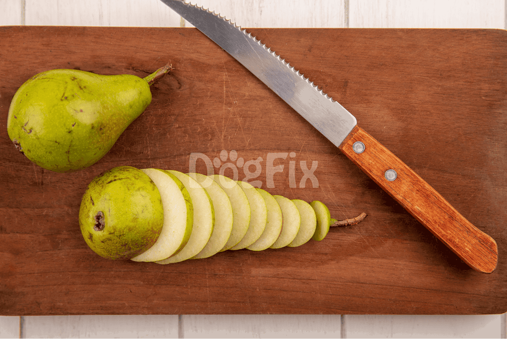 Pear sliced on wooden cutting board with a sharp knife, fresh fruit for healthy snacks or recipes.
