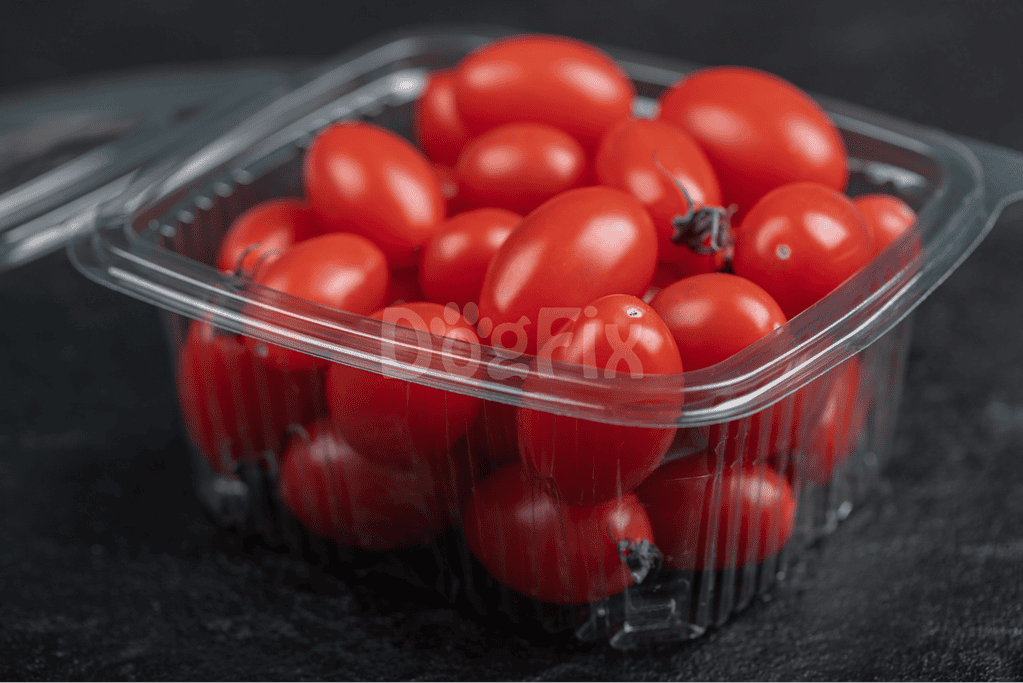 Fresh cherry tomatoes in clear plastic container for dogs' healthy treats.