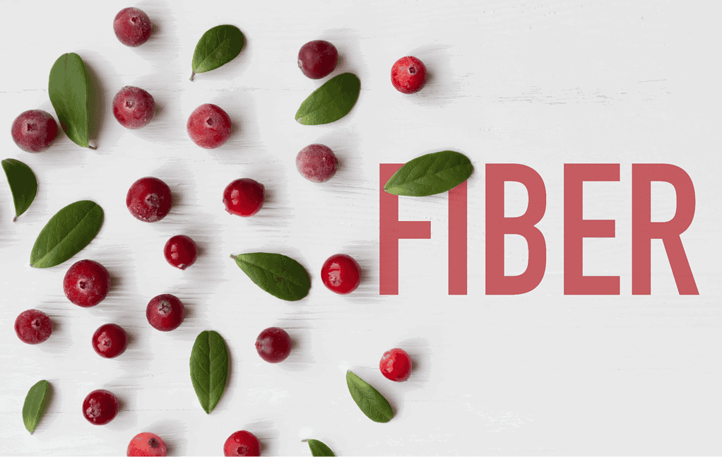 Fresh cranberries and green leaves on white wooden background enhancing dog health and nutrition.