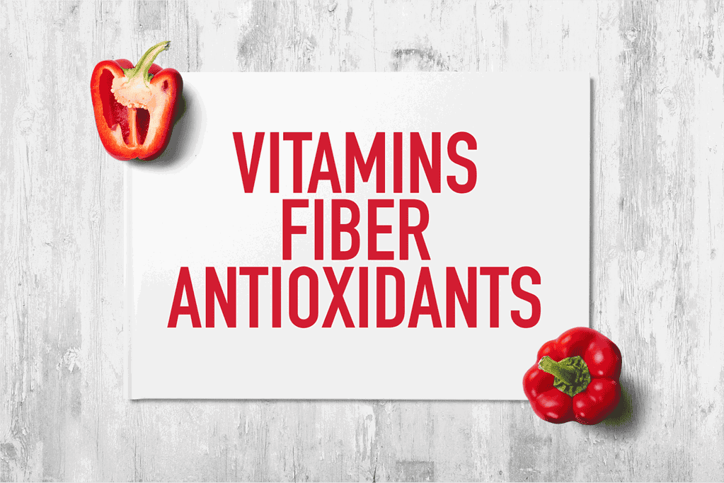 Fresh red pepper on white wood background.