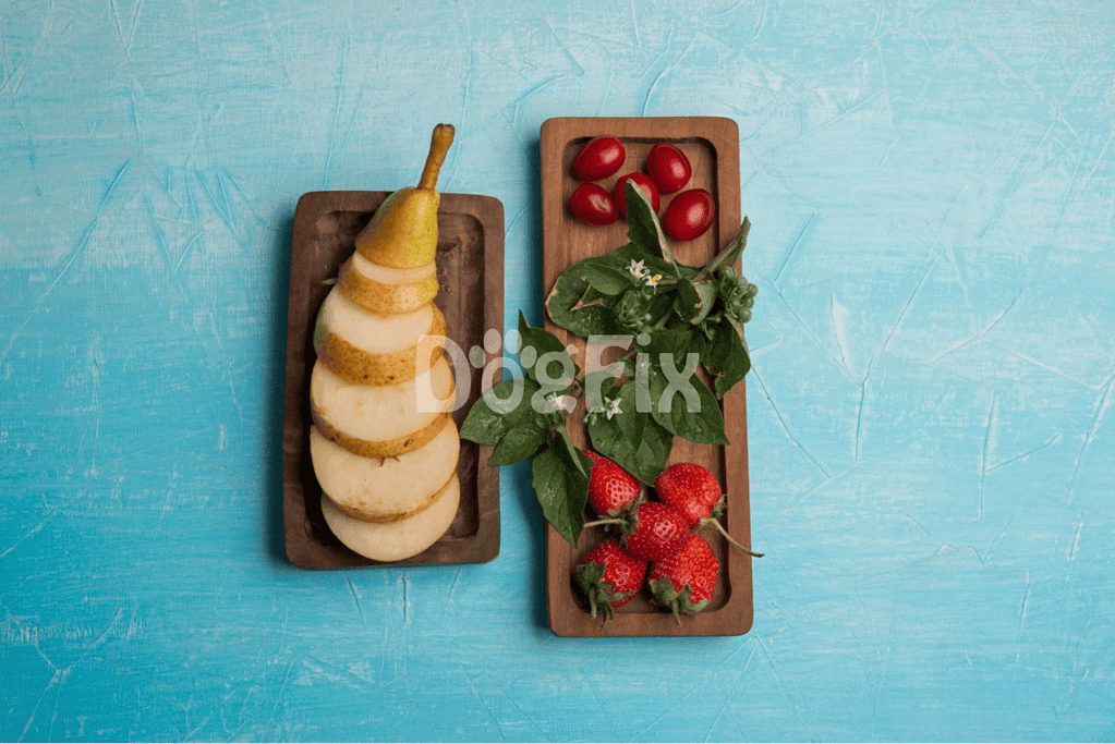 Healthy dog snacks with fresh strawberries, cherry tomatoes, leafy greens, and pear slices.