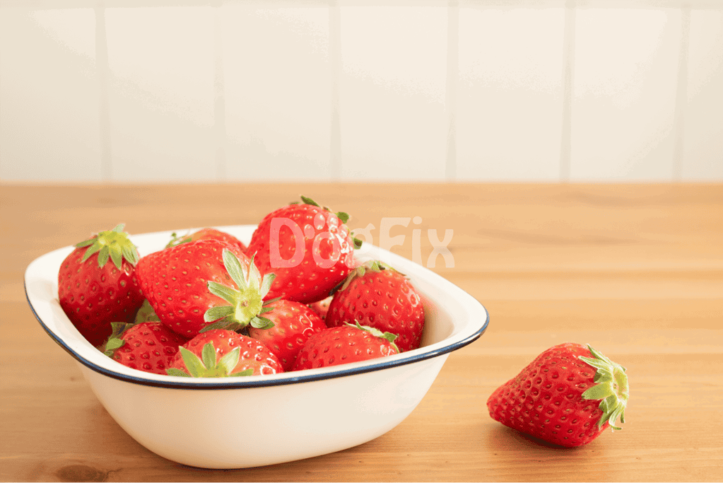 Bright, fresh strawberries in a bowl, perfect for healthy dog treats or snacks, on a wooden surface.