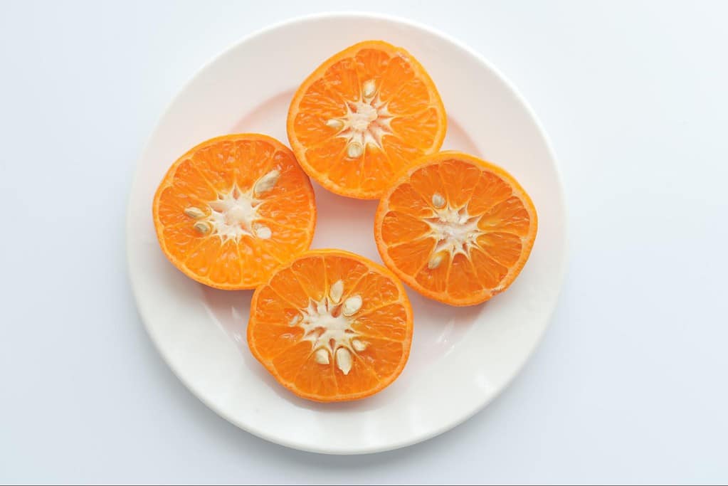 Fresh citrus fruit slices with bright orange color and juicy pulp.