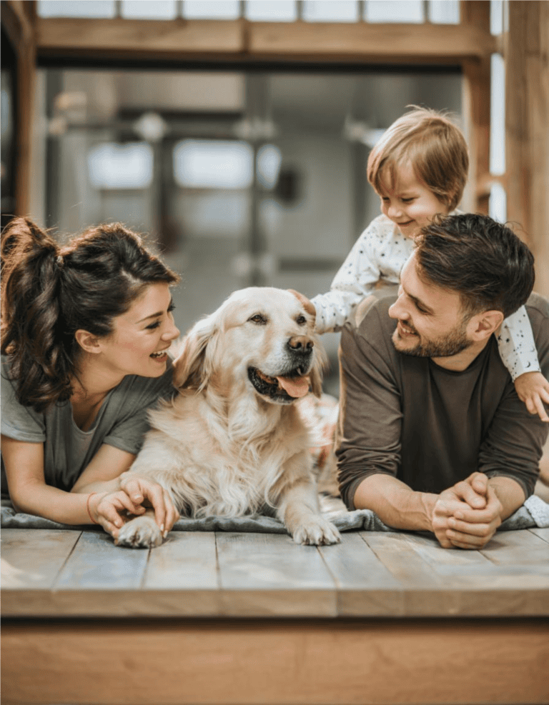 Adorable family enjoying quality time with their beloved dog indoors.