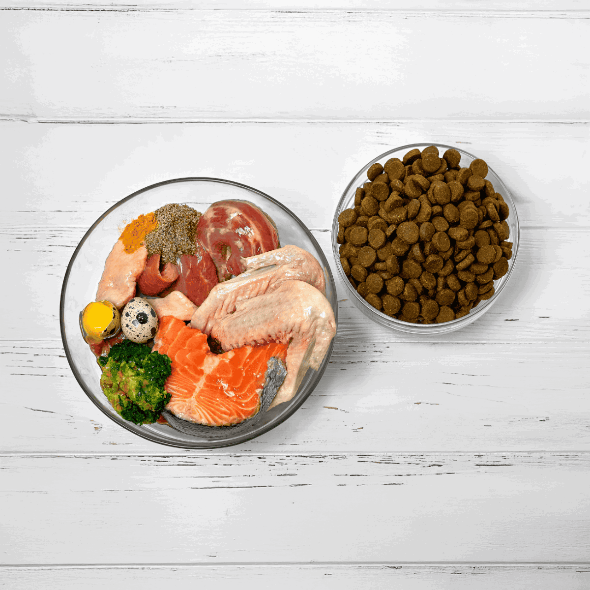 High-quality raw dog food ingredients, including meat, fish, vegetables, and kibble for healthy pups.