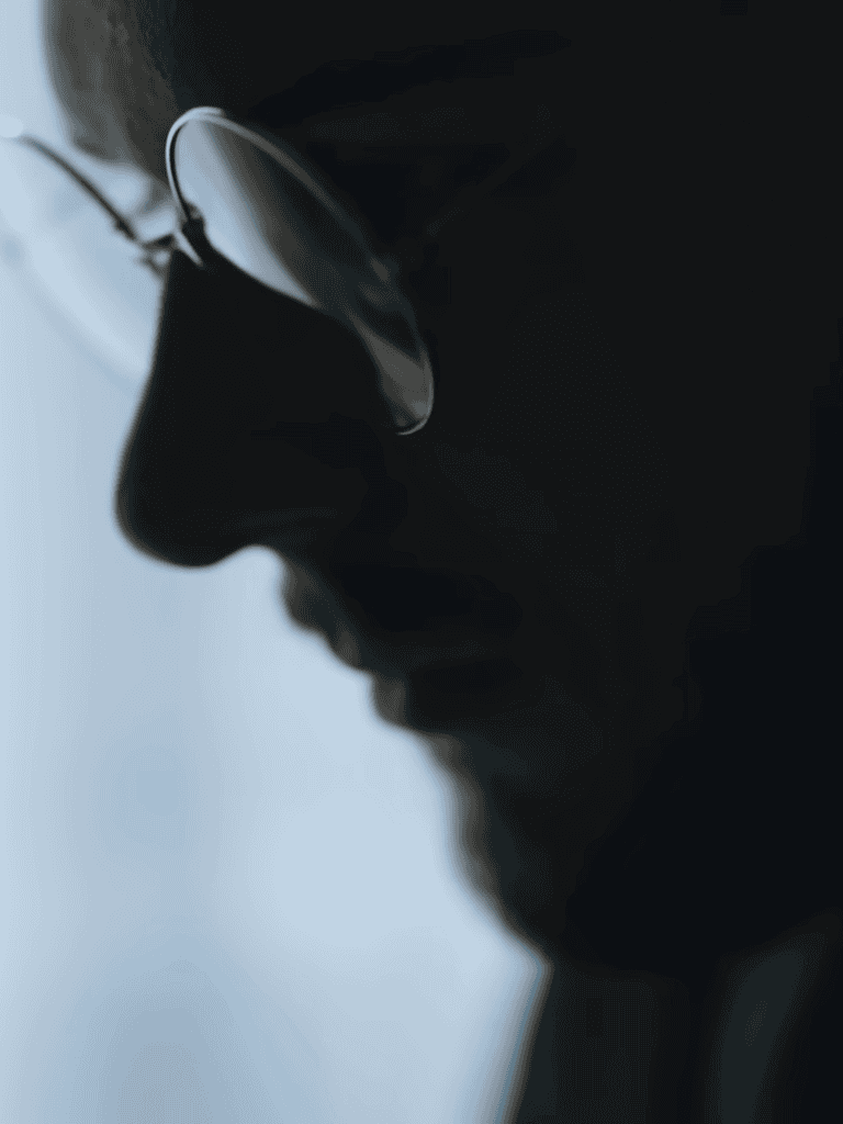 Close-up of a man wearing sunglasses, showing a calm and confident expression, symbolizing trust and reliability.