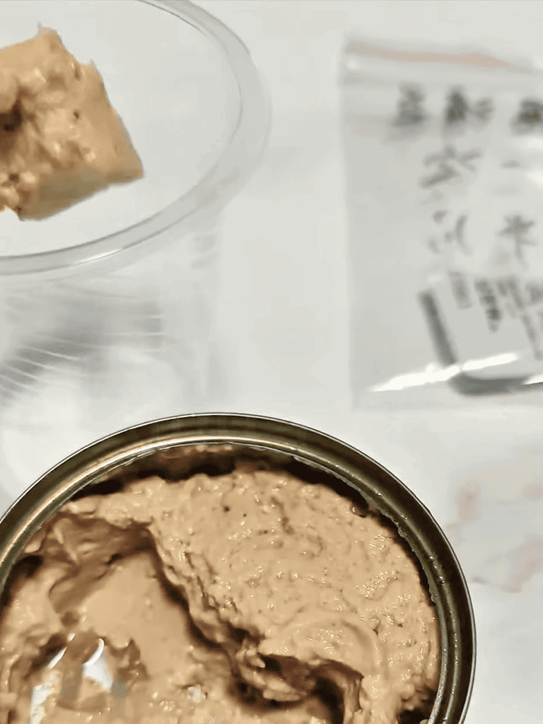 Healthy homemade dog food pate in a tin can and spoon.