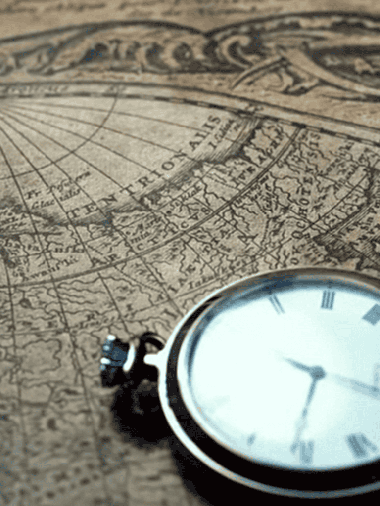 Antique pocket watch on vintage world map, symbolizing travel, exploration, and navigation history.