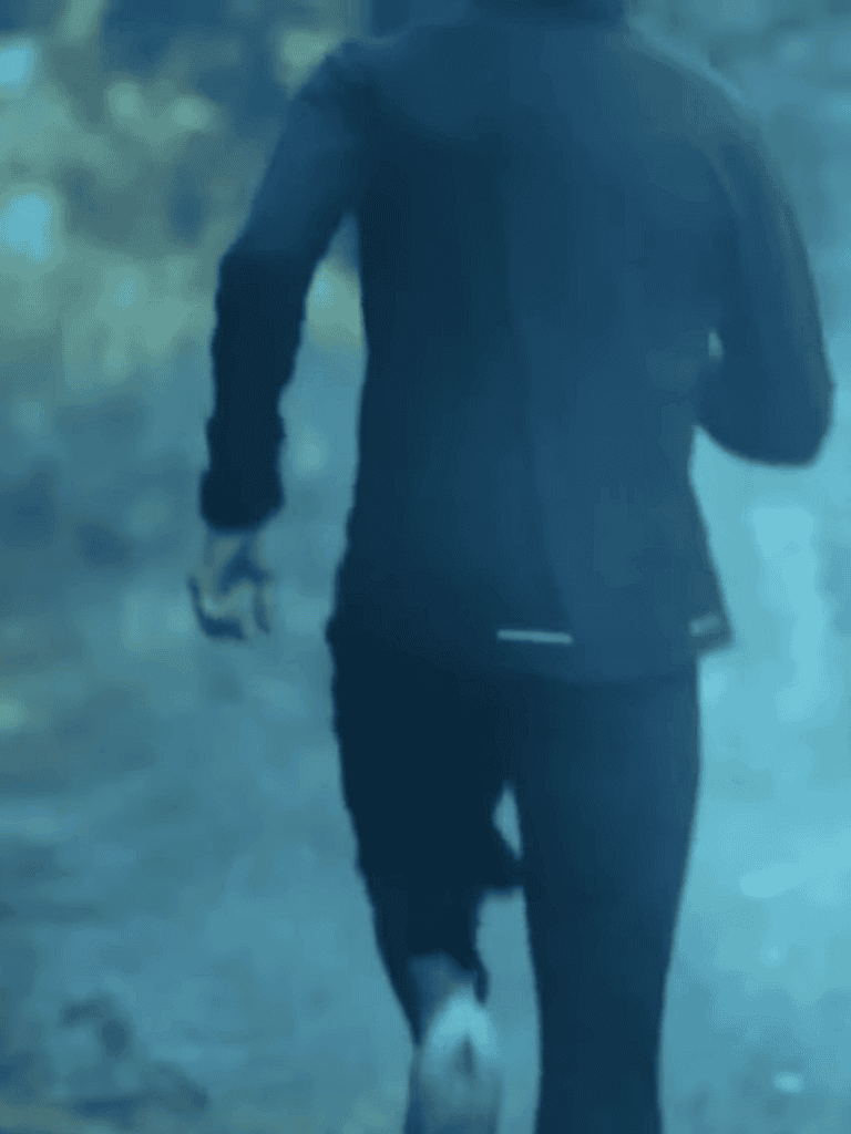 Man running with dog in park for exercise.