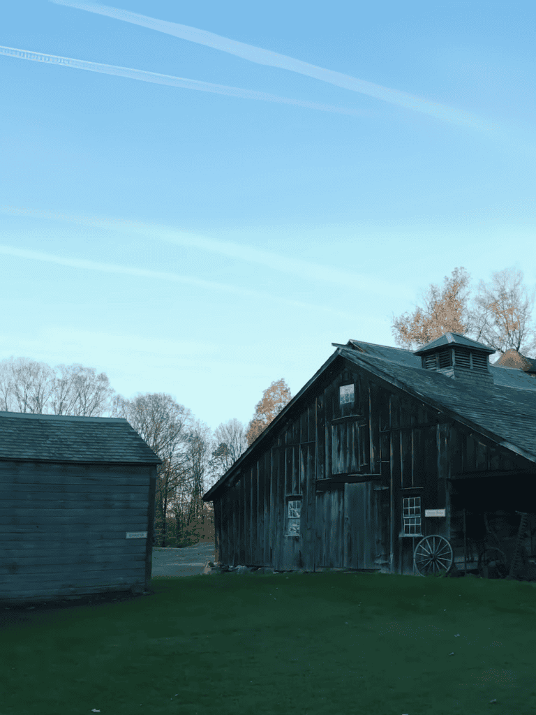 Rustic barn with weathered wood siding and rural farm setting.