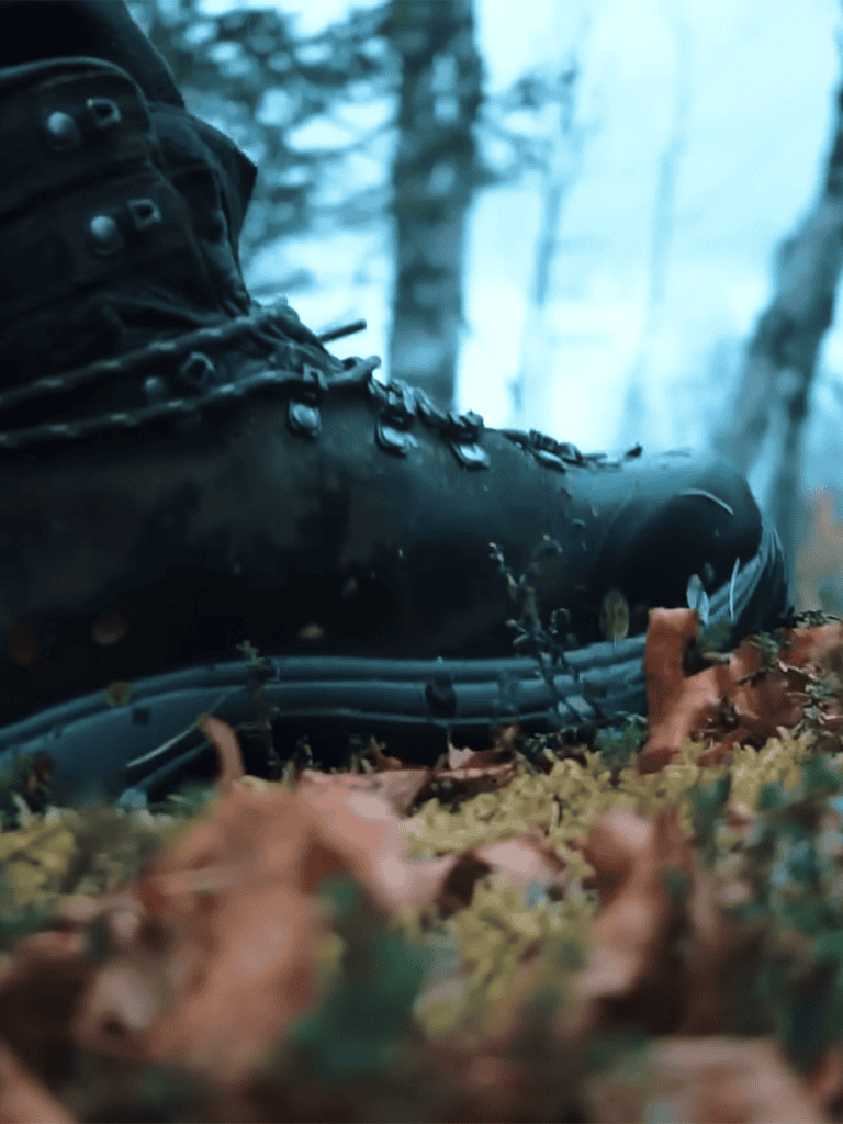 Durable outdoor hiking boot in a forest setting for trail walking.