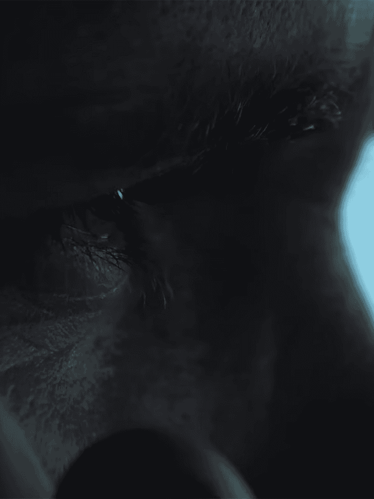 Close-up of a sleeping puppy's face, showing soft fur and peaceful expression.