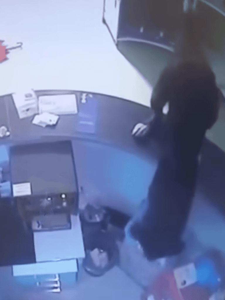 Surveillance image of a suspect attempting a bank robbery at Dogfix.com.