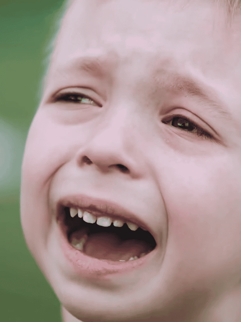 Close-up of a crying child's face showing distress and sadness.