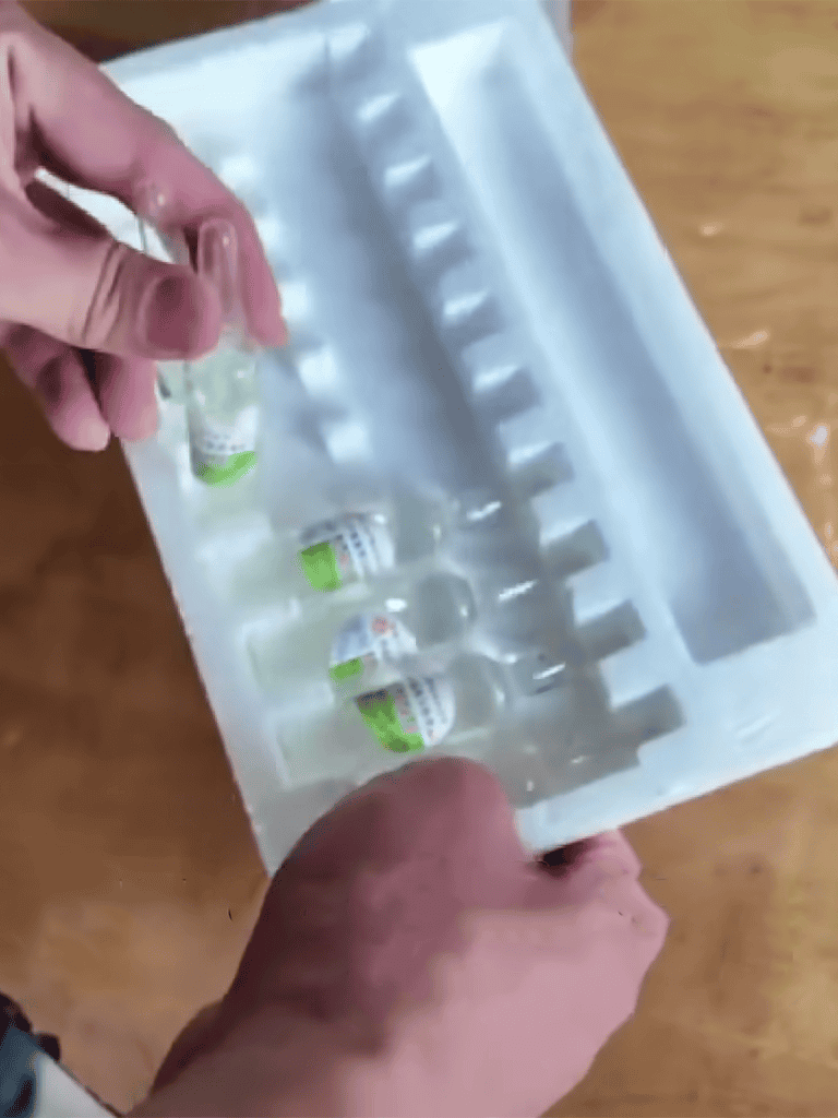 Close-up of vaccine vials in protective packaging for pet health.