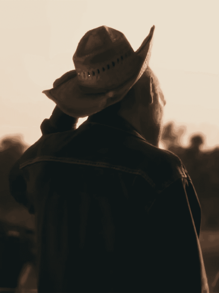 Iconic cowboy hat and rugged attire, capturing the spirit of the American West.