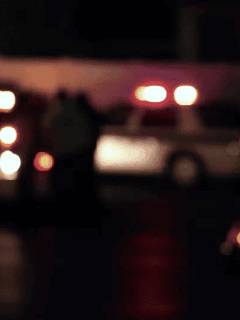 Blurry photo of cars with headlights glowing at night, creating a vibrant light display.
