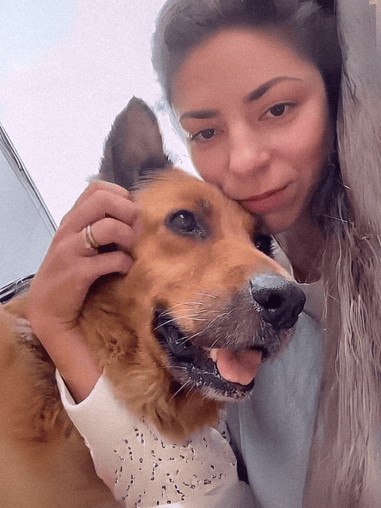 Dog and owner hug, showing love and companionship.